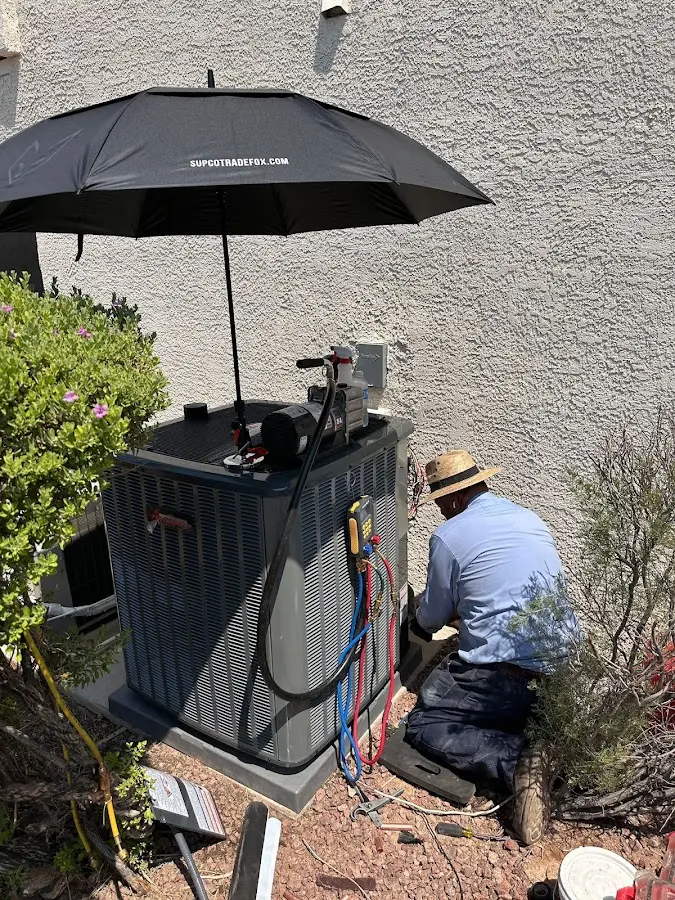 HVAC technician performing outdoor AC maintenance in Montrose